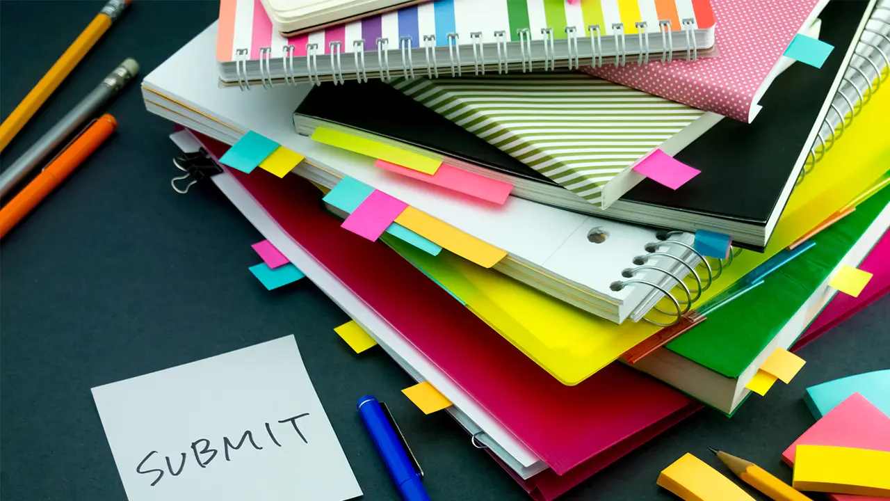 Various books and pens on a table